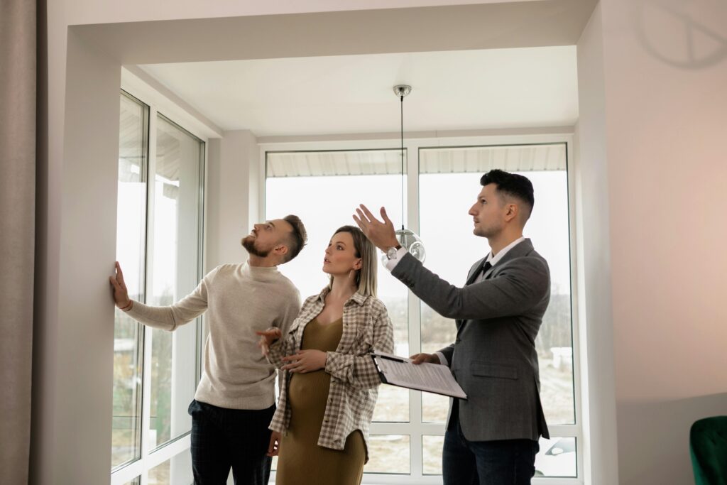 A property specialist showing a couple a home