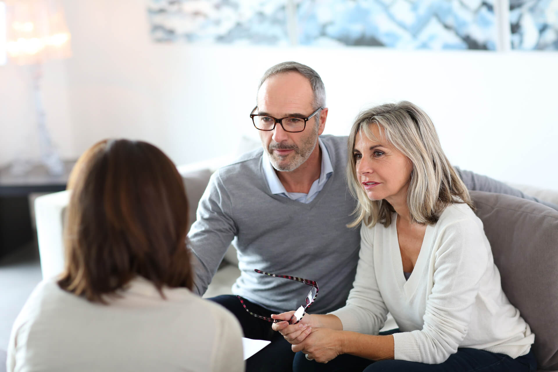 Man and woman talking with a woman